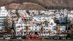 A coastal town with a prominent white building labeled "The Winchester." - The Winchester Hotel by NEWMARK (Cape Town)
