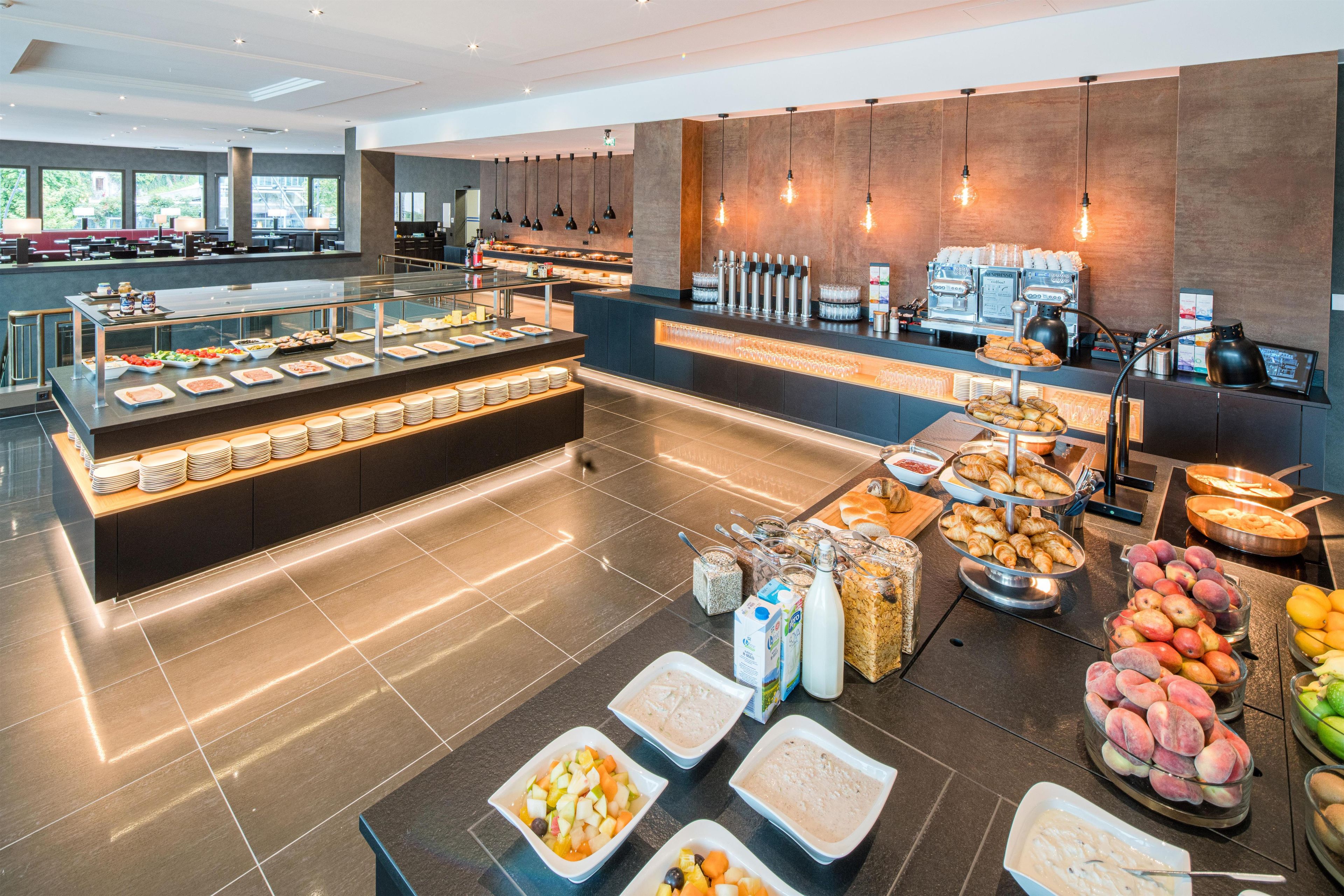A buffet area with various food options and a coffee station.