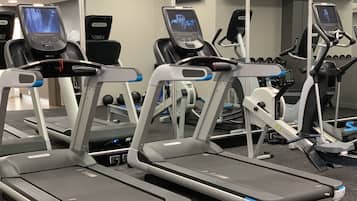 A gym with multiple treadmills and exercise equipment.