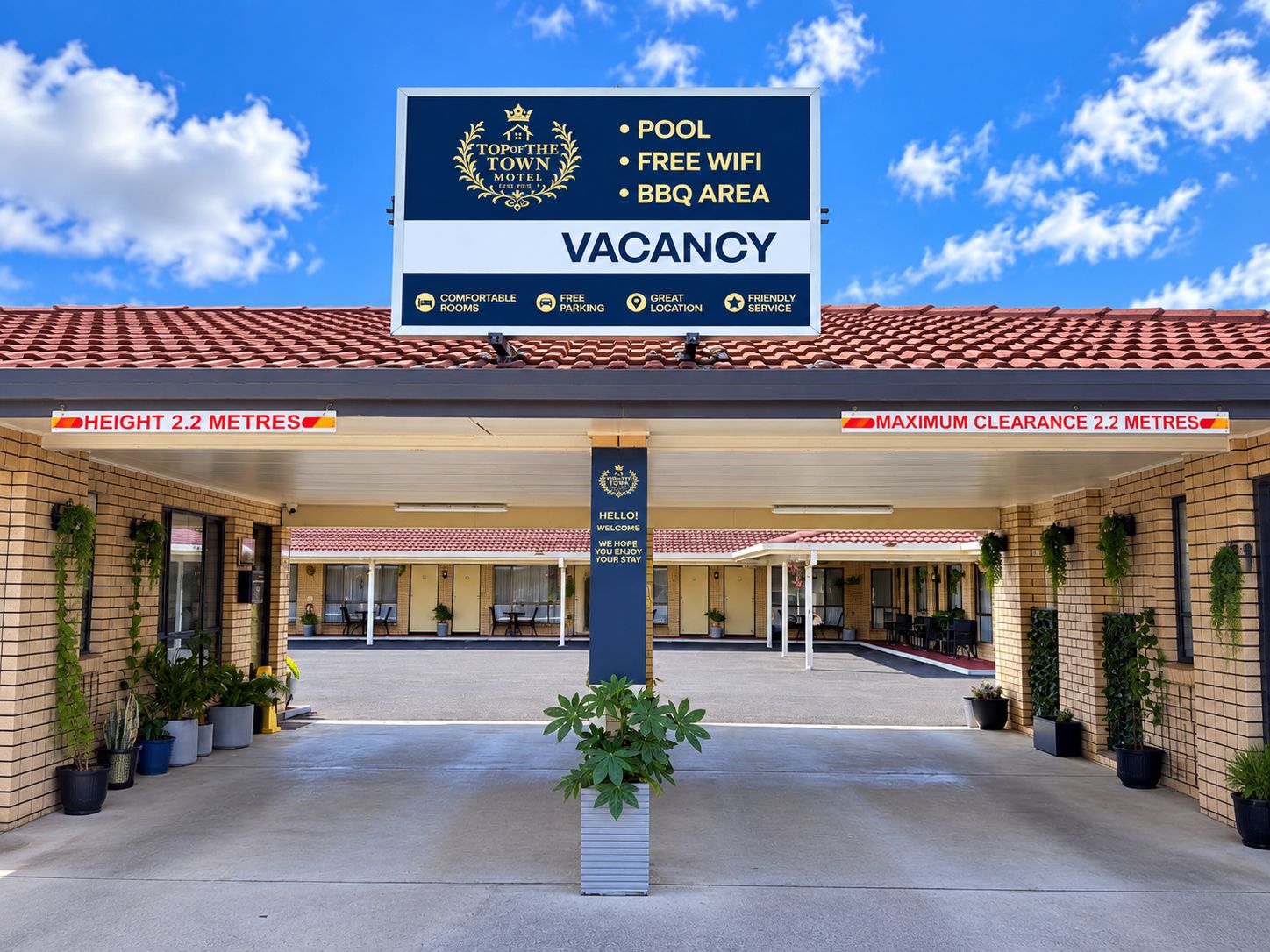 A hotel with a sign indicating a pool, free wifi, and BBQ area. It has a height of 2.2 meters and a maximum clearance of 2.2 meters.