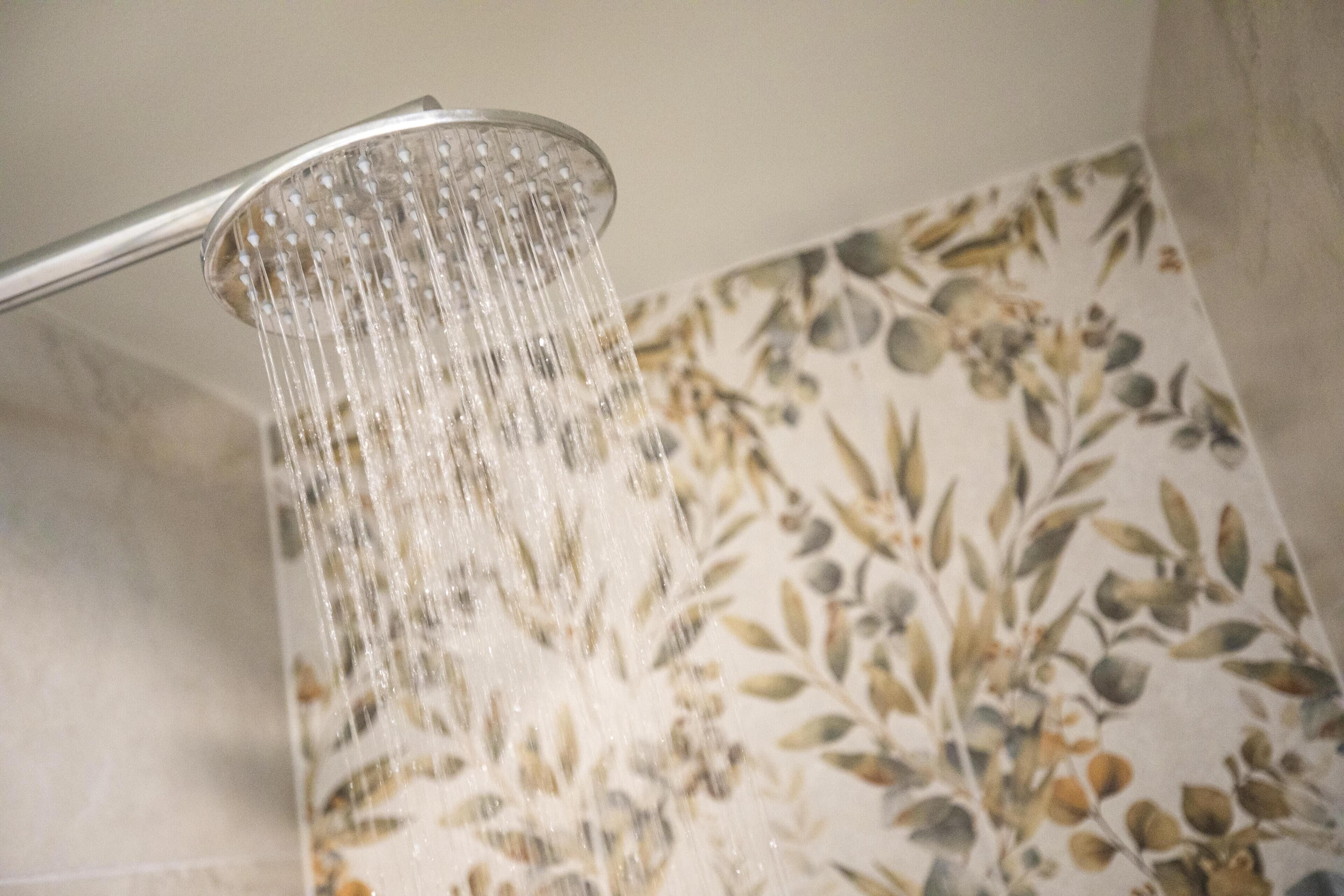 A showerhead with water flowing from it.