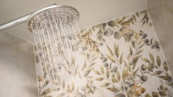 A showerhead with water flowing from it.