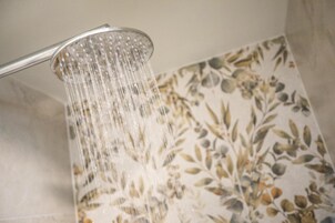 A showerhead with water flowing from it.