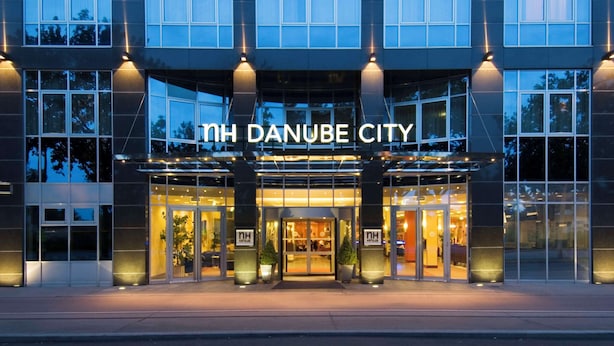 The exterior of the Danube City hotel with a modern design, featuring large glass windows and a prominent entrance. - NH Danube City (Vienna)