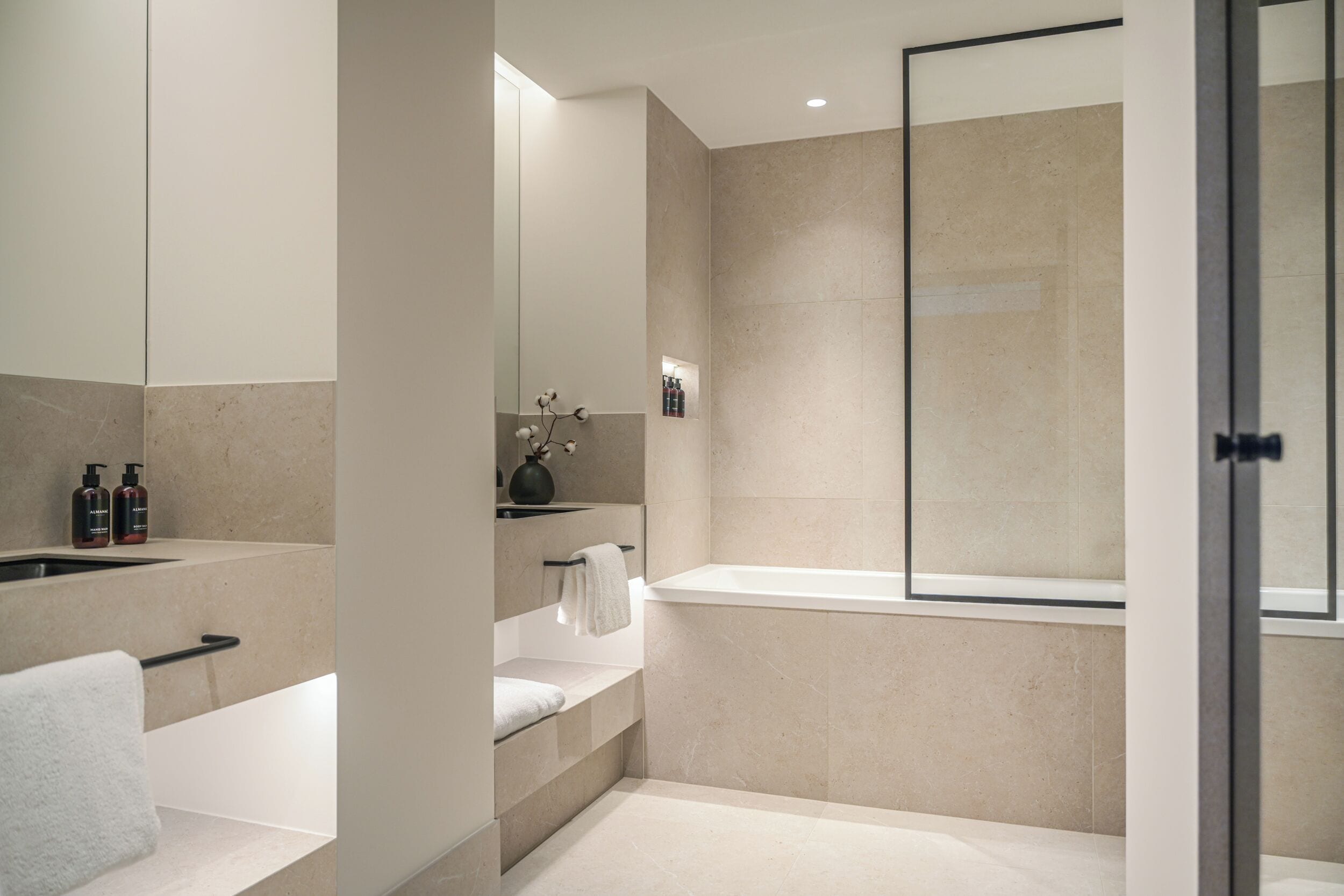 A modern bathroom with a bathtub, a shower, and a vanity with a mirror.