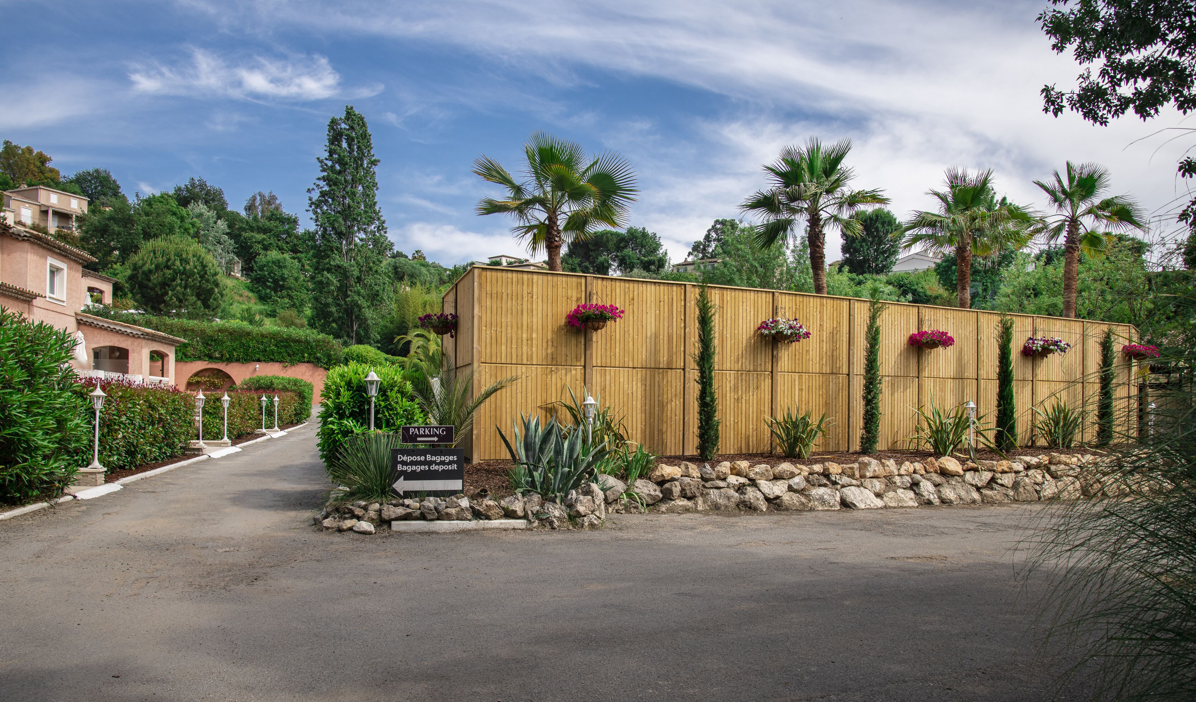 A gated entrance with a sign indicating a parking area.