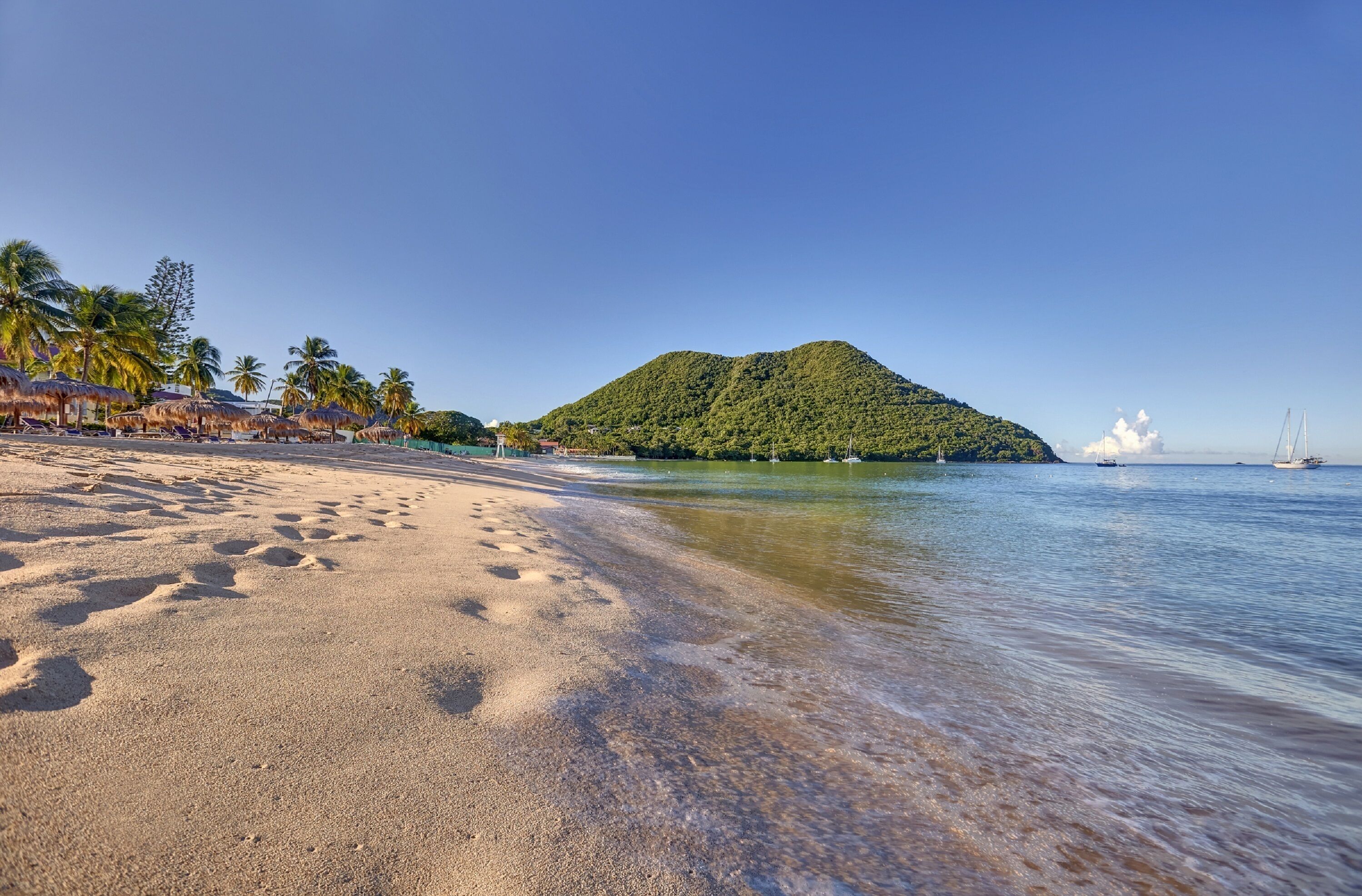 On the beach, white sand, sun loungers, beach umbrellas