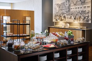 A breakfast buffet with various food items and condiments.