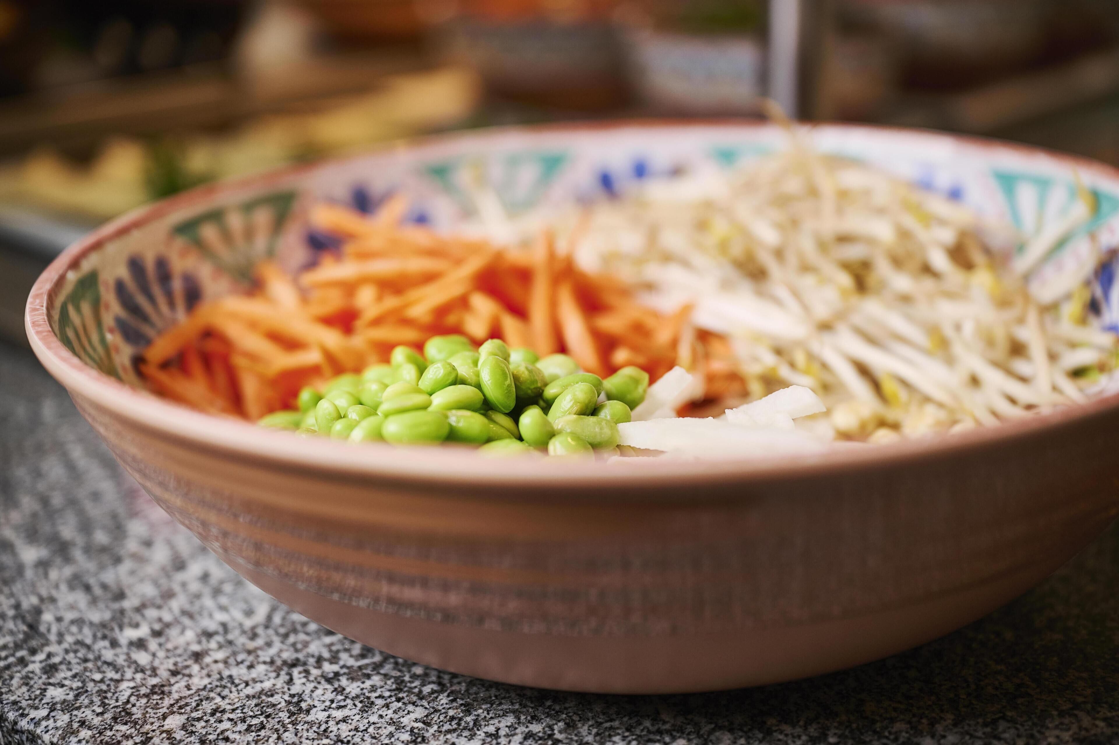 A bowl with various vegetables on a countertop.