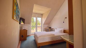 A bedroom with a bed, a desk, a chair, a window, and a painting on the wall.