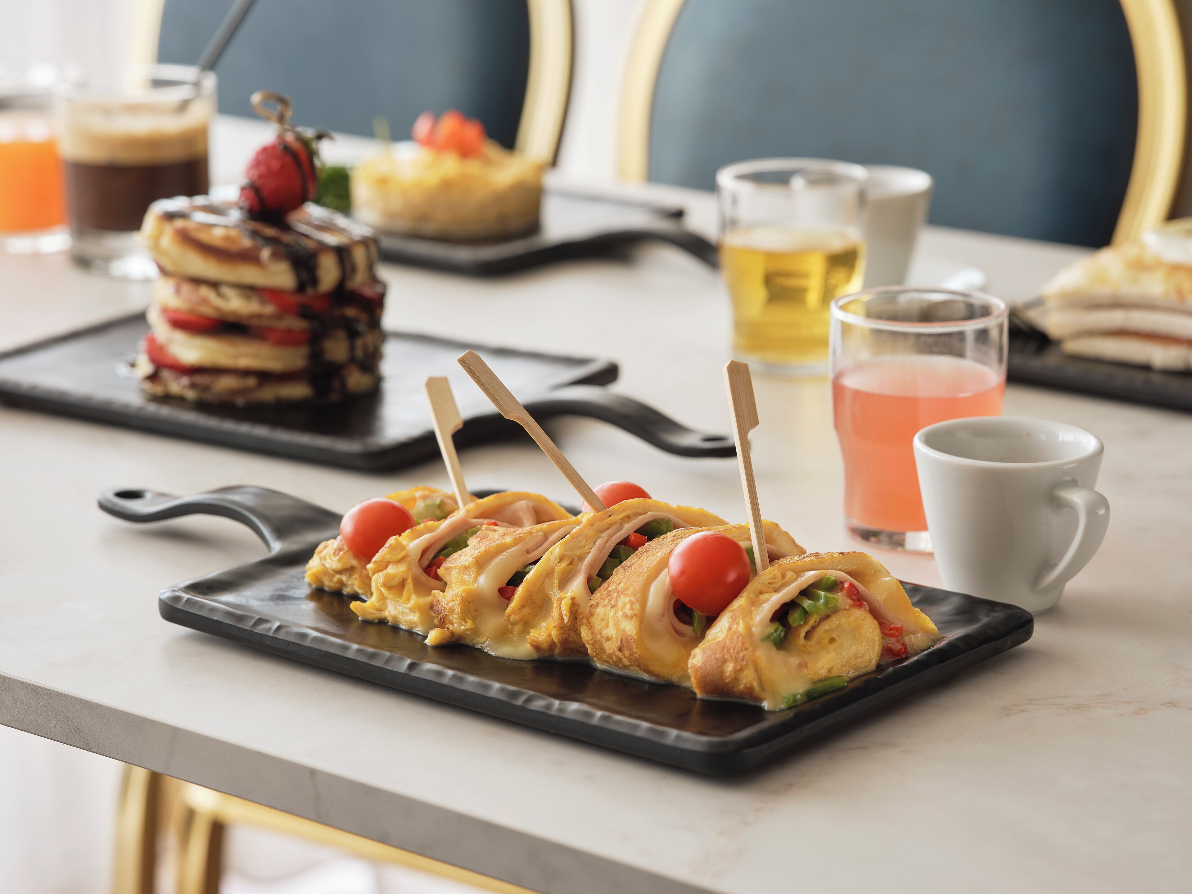 A dining table with a variety of food items and drinks.