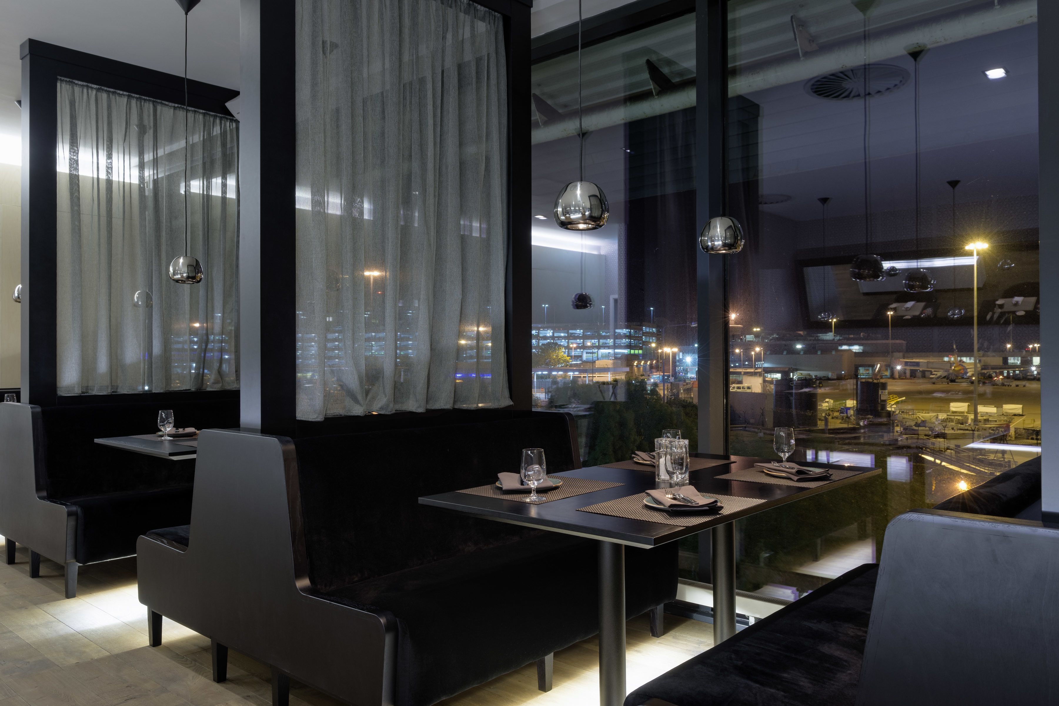 A modern restaurant with a view of the cityscape.