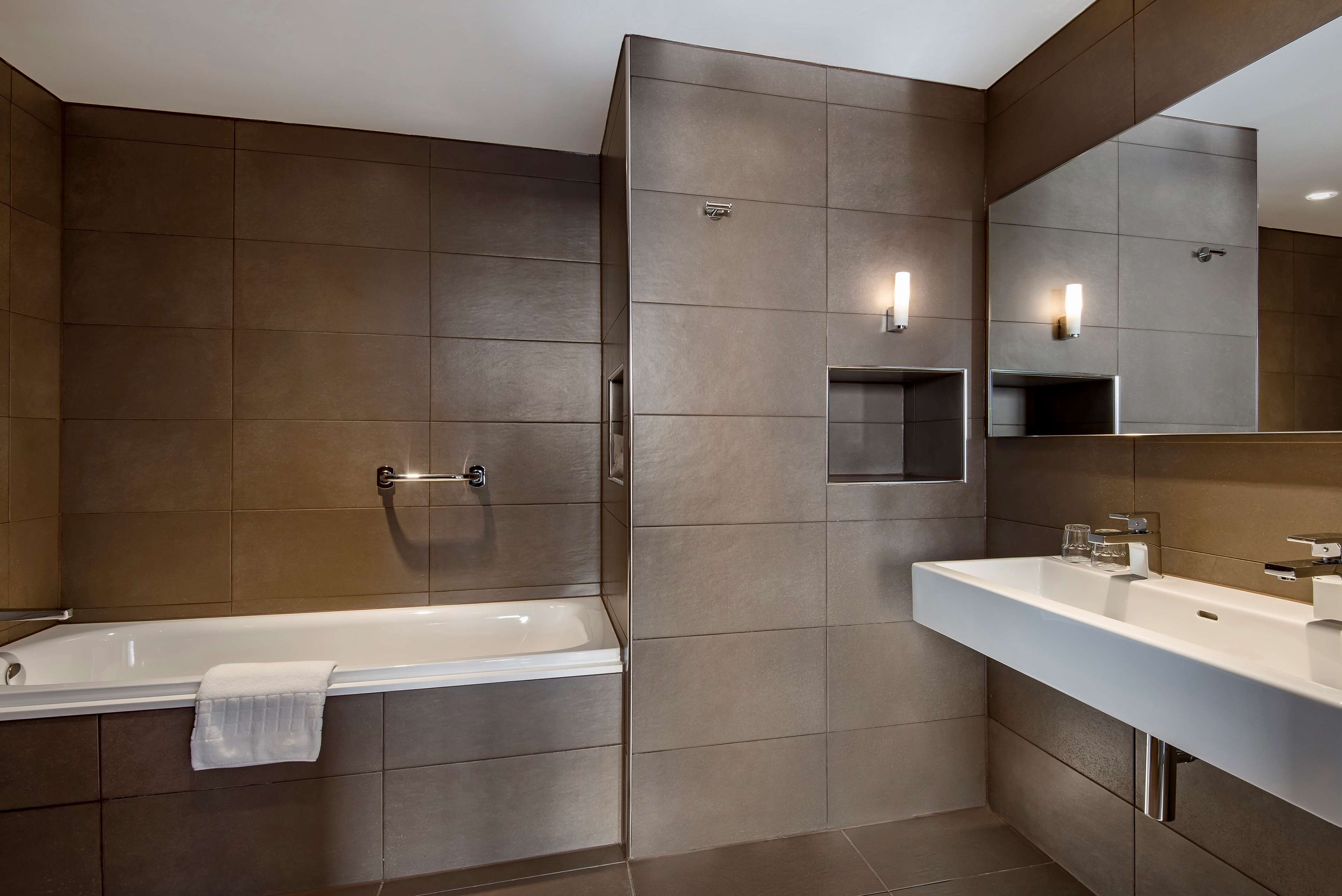 combined shower/bathtub, designer toiletries, hair dryer, towels