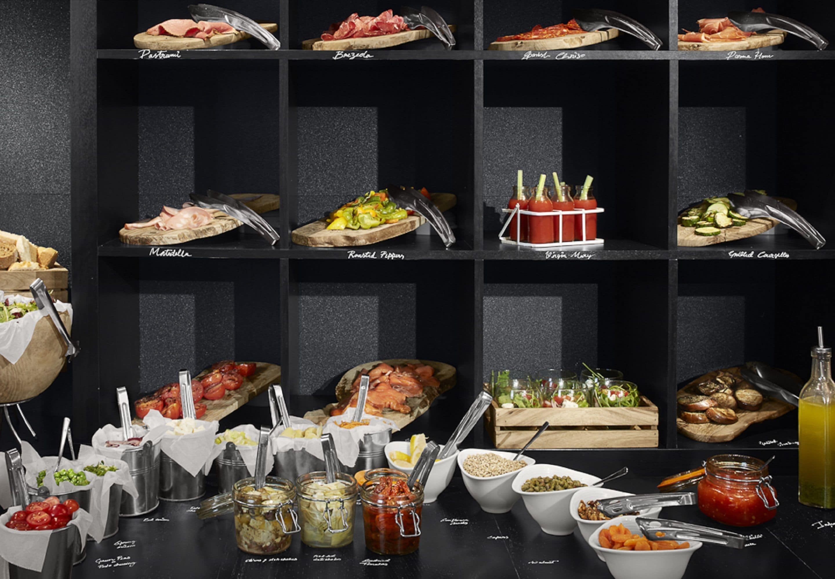A buffet with various food items and condiments.