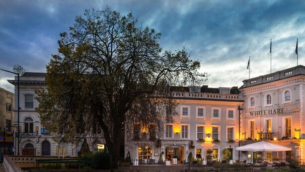 A historic building with a large tree in front, named "White Hart Hotel".