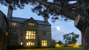 A stone building with multiple windows and a well-maintained lawn. - Bodysgallen Hall & Spa (Llandudno)