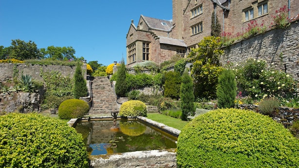 A historic building with a stone facade, a small pond, and well-manicured gardens. - Bodysgallen Hall & Spa (Llandudno)