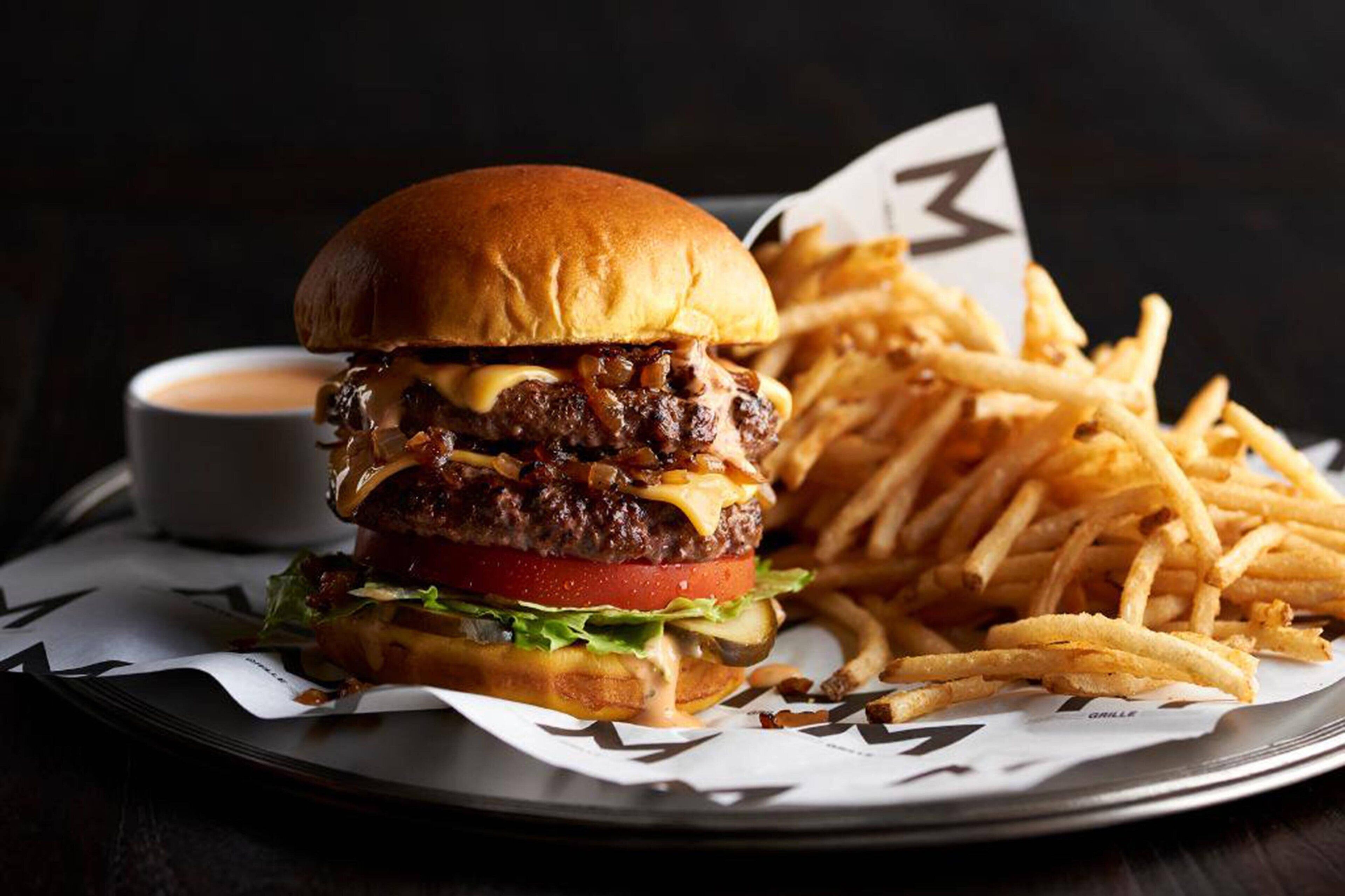 A burger with fries on a plate.