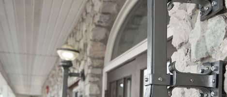 Outdoor wall-mounted lights along a stone building's exterior.
