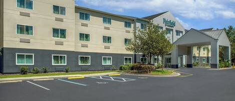 A Fairfield by Marriott hotel with a modern facade, multiple windows, and a parking lot with handicapped parking spaces.