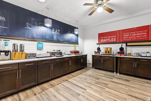 Enjoy cooking and dining in this well-equipped kitchen with a long countertop, coffee machine, toaster, and blender.