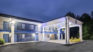 A motel with a covered parking area and a gas station. - Days Inn by Wyndham Hamilton (Hamilton)