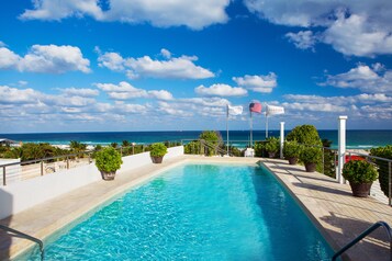 Outdoor pool, open 7:00 AM to 7:00 PM, pool umbrellas, pool loungers