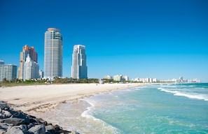 Beach nearby, white sand, beach towels, beach volleyball