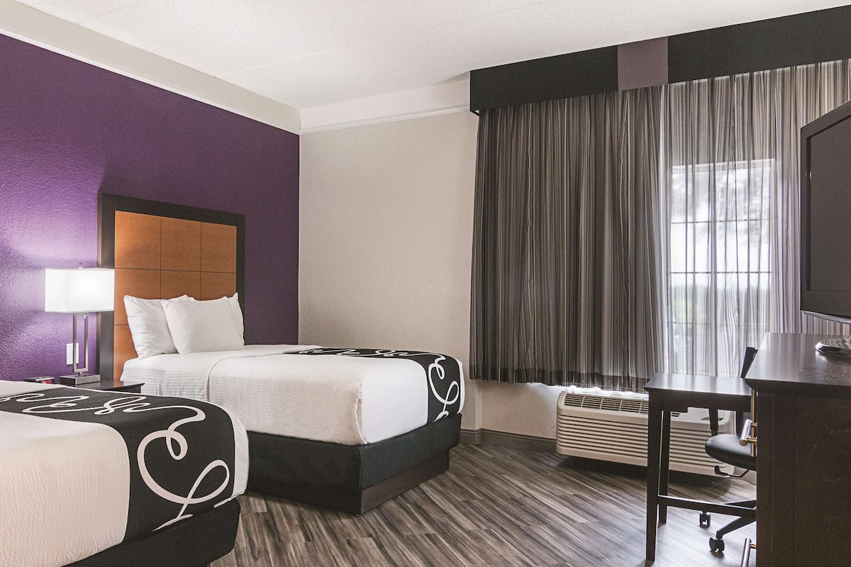 Premium bedding, desk, laptop workspace, blackout drapes