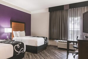Premium bedding, desk, laptop workspace, blackout drapes
