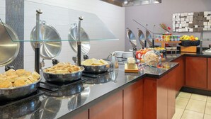 A buffet area with various food items, including waffles, biscuits, and a coffee station. - DoubleTree by Hilton Atlanta Airport (Atlanta)