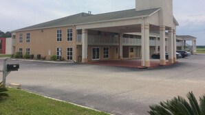A two-story building with a covered front porch and a central tower. - Days Inn by Wyndham Donalsonville (Donalsonville)