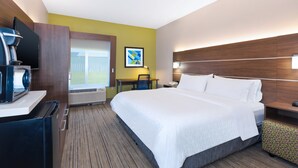 A hotel room with a bed, a desk, a chair, a coffee machine, a TV, and a window with a view of the outdoors. - Holiday Inn Express & Suites Three Rivers by IHG (Three Rivers)