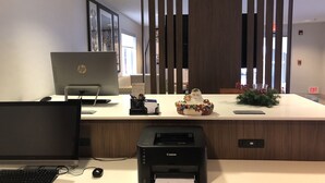 A modern office desk with an HP laptop, a Canon printer, and a decorative ceramic piece. - Holiday Inn Express Mt Vernon by IHG (Mount Vernon)