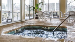 A heated indoor pool area with a hot tub, surrounded by large windows and white chairs. - Bluegreen Vacations Harbour Lights, an Ascend Collection Resort (Myrtle Beach)