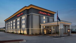 A Hampton Inn hotel with a modern facade, a welcoming entrance, and a flagpole with the American flag. - Hampton Inn Simpsonville (Simpsonville)