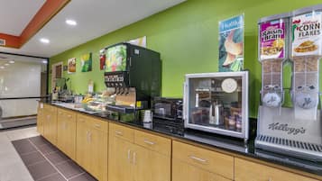 A breakfast bar with a coffee machine, cereal dispensers, and a refrigerated display.