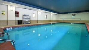 Una piscina con un borde de baldosas, una silla de salvavidas y un letrero que indica una profundidad de 3 metros.