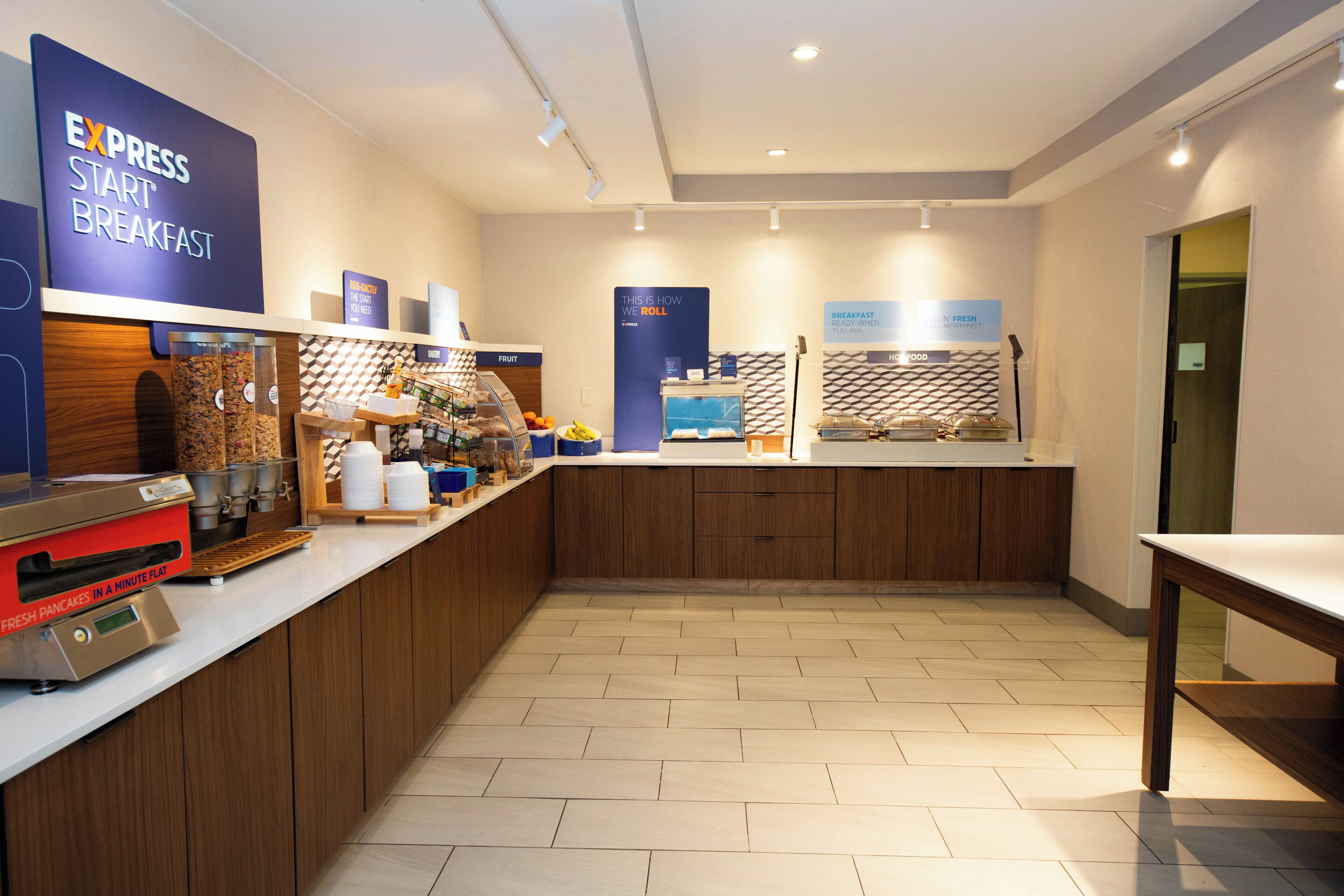 A breakfast area with a self-service station, a coffee machine, and a sign indicating breakfast is ready when the machine is full.