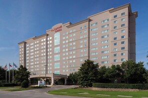 A large, multi-story hotel with a prominent 'Marriott Suites' sign. - Dallas Marriott Suites Medical/Market Center (Dallas)
