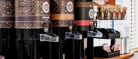 A coffee station with multiple dispensers labeled 'dark roast' and 'light roast' coffee.