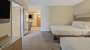 A hotel room with a bed, a desk, a TV, and a bathroom visible through an open door. - Holiday Inn Express Hotel & Suites Torrington by IHG (Torrington)