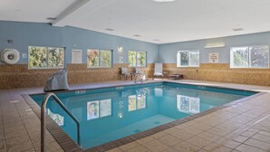 An indoor swimming pool with clear pool rules signs, windows, and a ceiling fan. - Holiday Inn Express Hotel & Suites Torrington by IHG (Torrington)