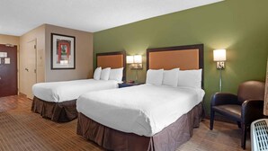 A hotel room with two beds, a chair, a desk, and a wall-mounted picture. - Extended Stay America Suites San Diego Oceanside (Oceanside)