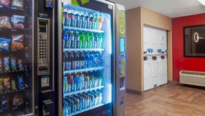 A vending machine with snacks and drinks, a cash price display, and a water dispenser. - Extended Stay America Suites San Diego Oceanside (Oceanside)