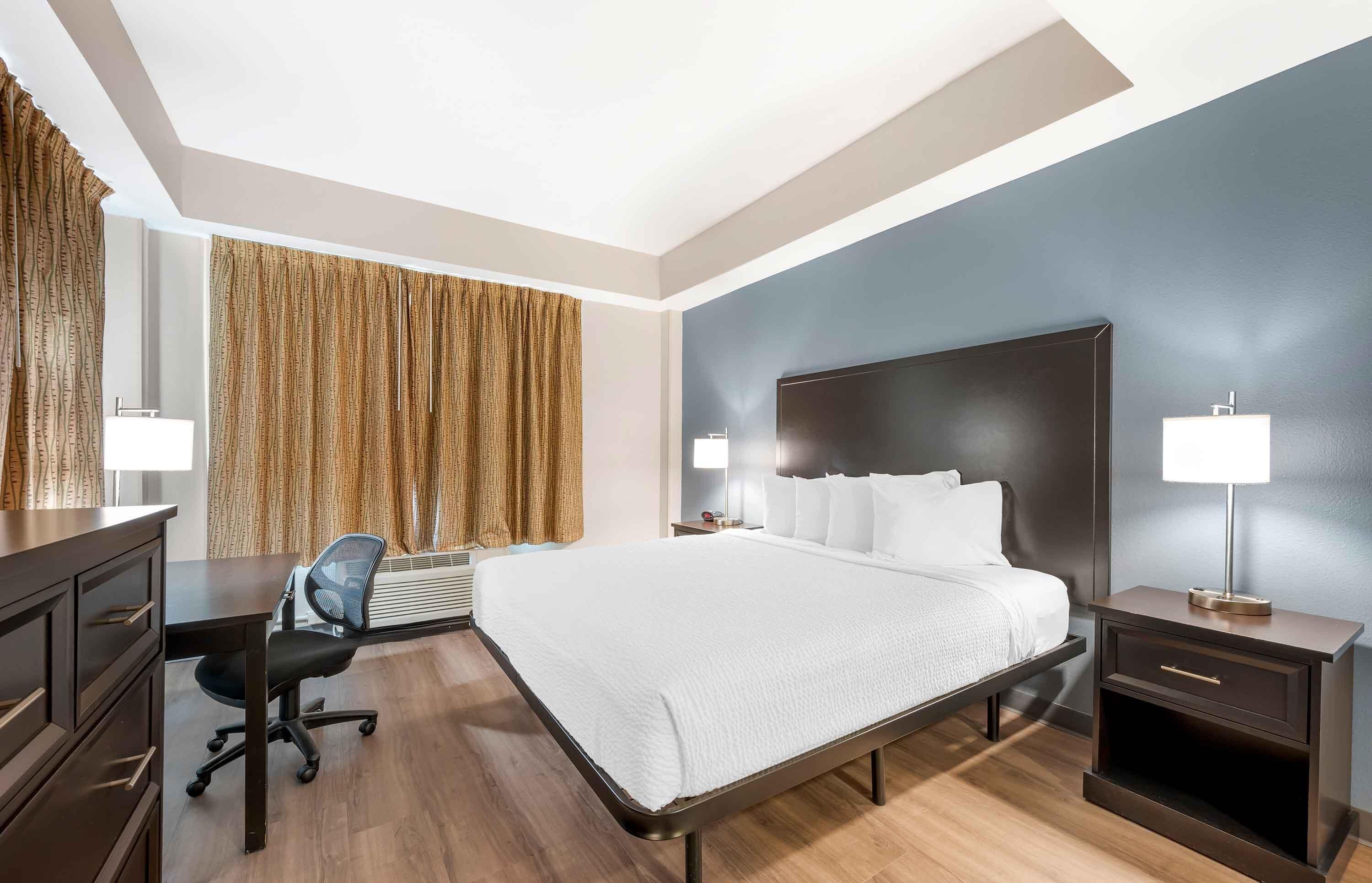 desk, laptop workspace, blackout curtains, iron/ironing board