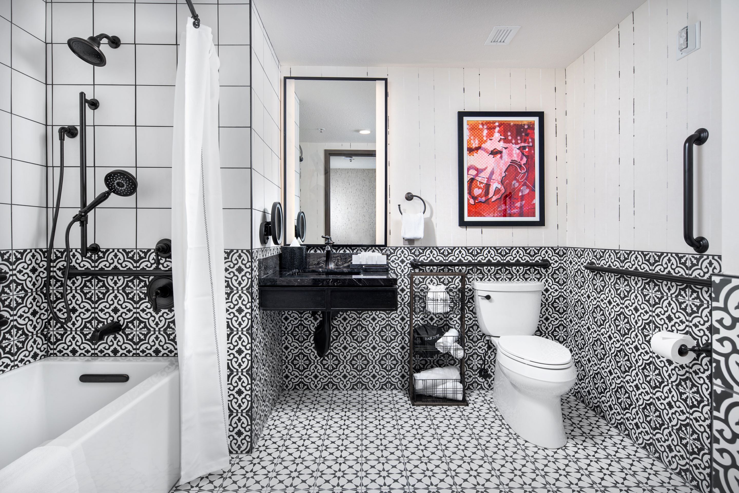 A bathroom with a black and white patterned tile floor, a white toilet, a black sink, and a shower with a white curtain.
