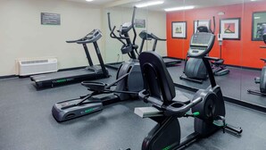 A gym with various exercise equipment including treadmills, an elliptical, and a stationary bike. - Extended Stay America Select Suites Raleigh RTP 4610 Miami B (Durham)