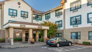 A hotel entrance with a 'Lobby' sign, a parking area, and a wheelchair accessibility sign. - Extended Stay America Suites Portland Beaverton/Hillsboro (Beaverton)
