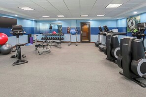 A gym with cardio machines, free weights, and exercise balls. - Four Points by Sheraton Bentonville (Bentonville)